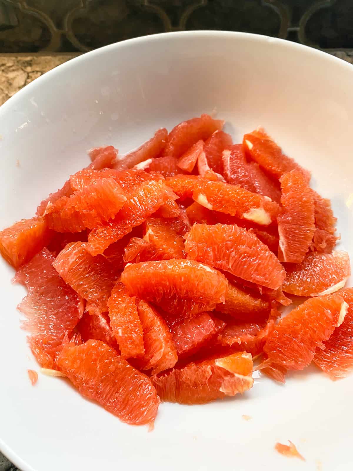 Grapefruit and orange segments in a bowl.