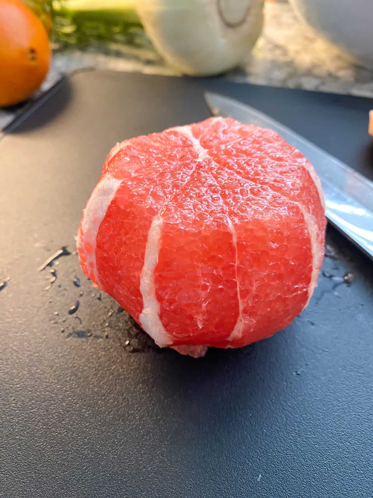 A grapefruit with the peel and pith cut off.