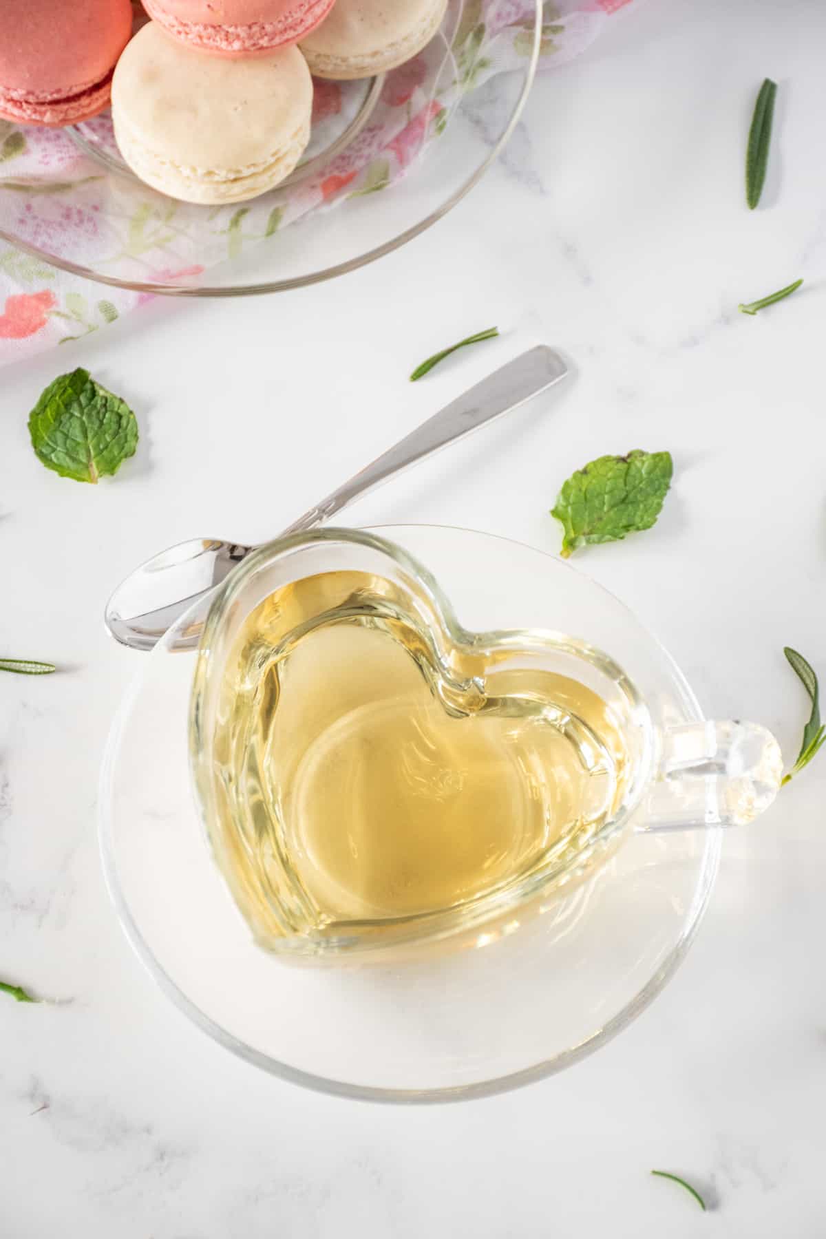 Tea in a heart shaped glass teacup.