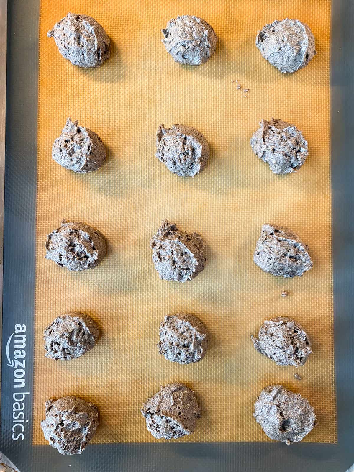 Batter scooped onto a lined baking sheet.