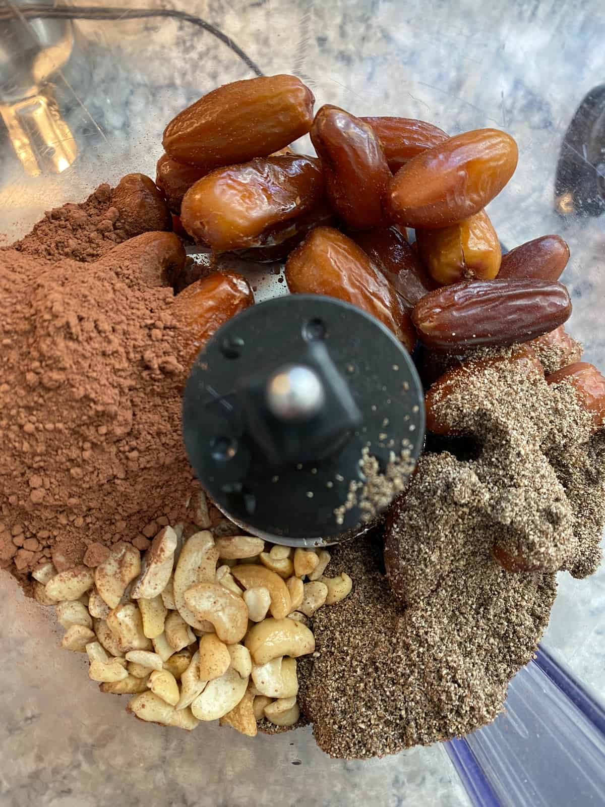 Whole ingredients for cherry truffles in a food processor.