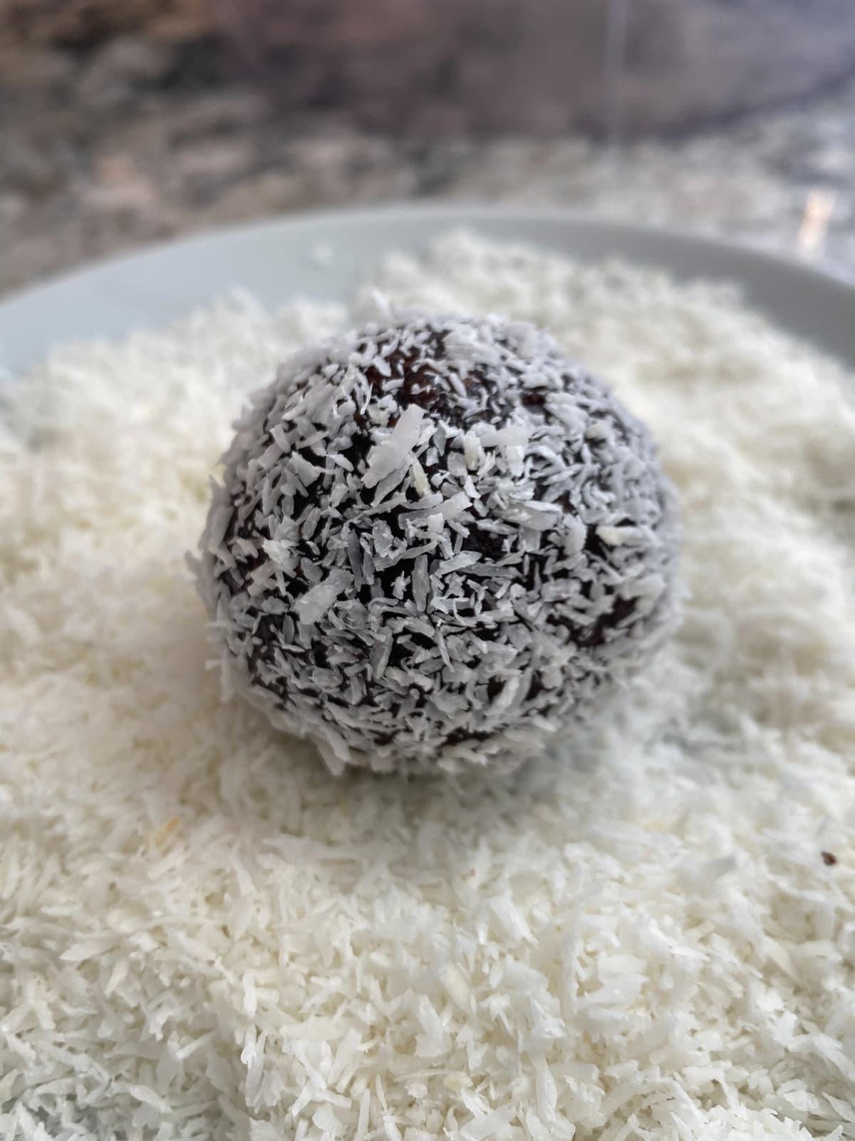 Cherry truffle rolled in shredded coconut.