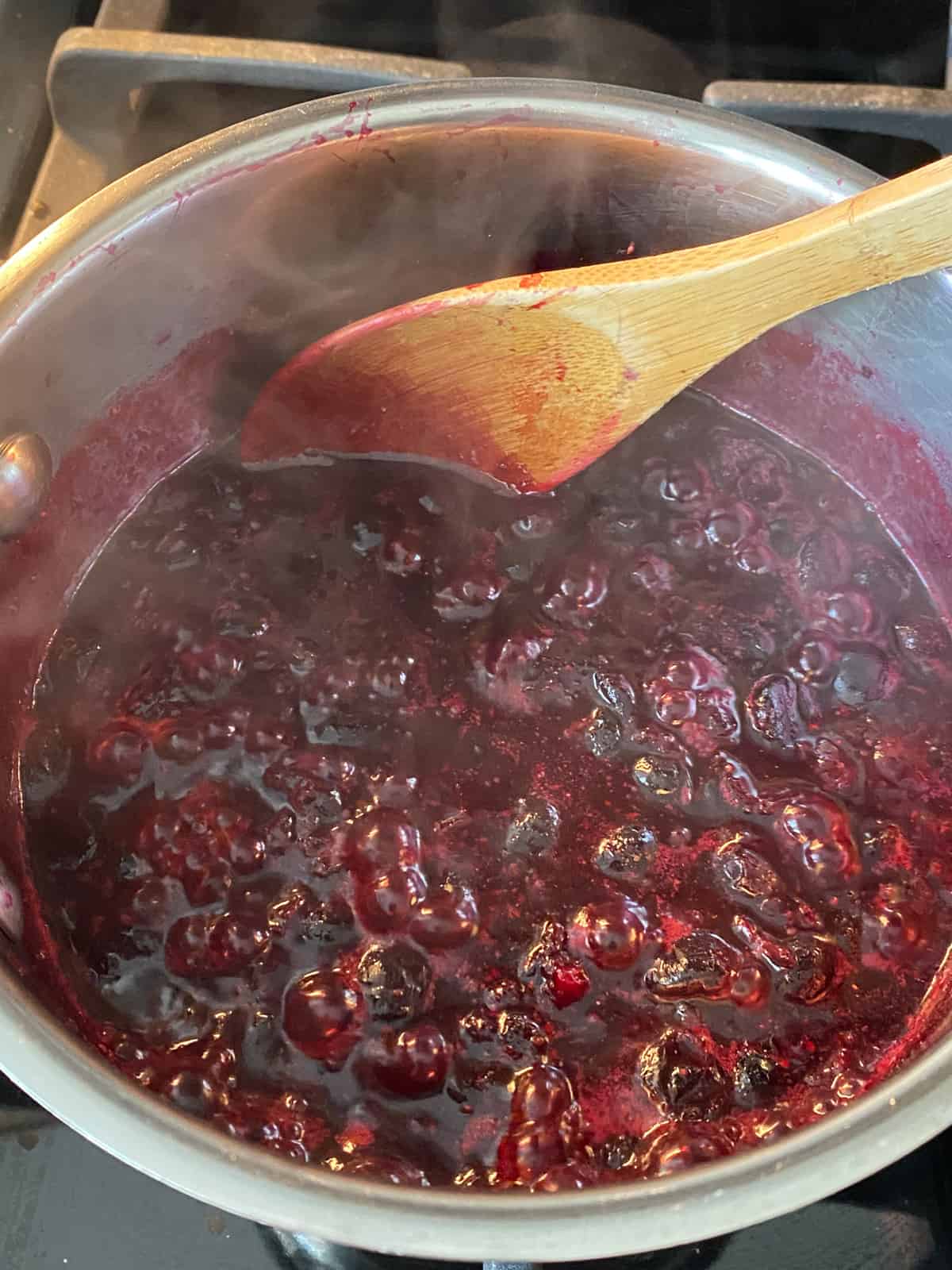 Simmering pot of blueberries.