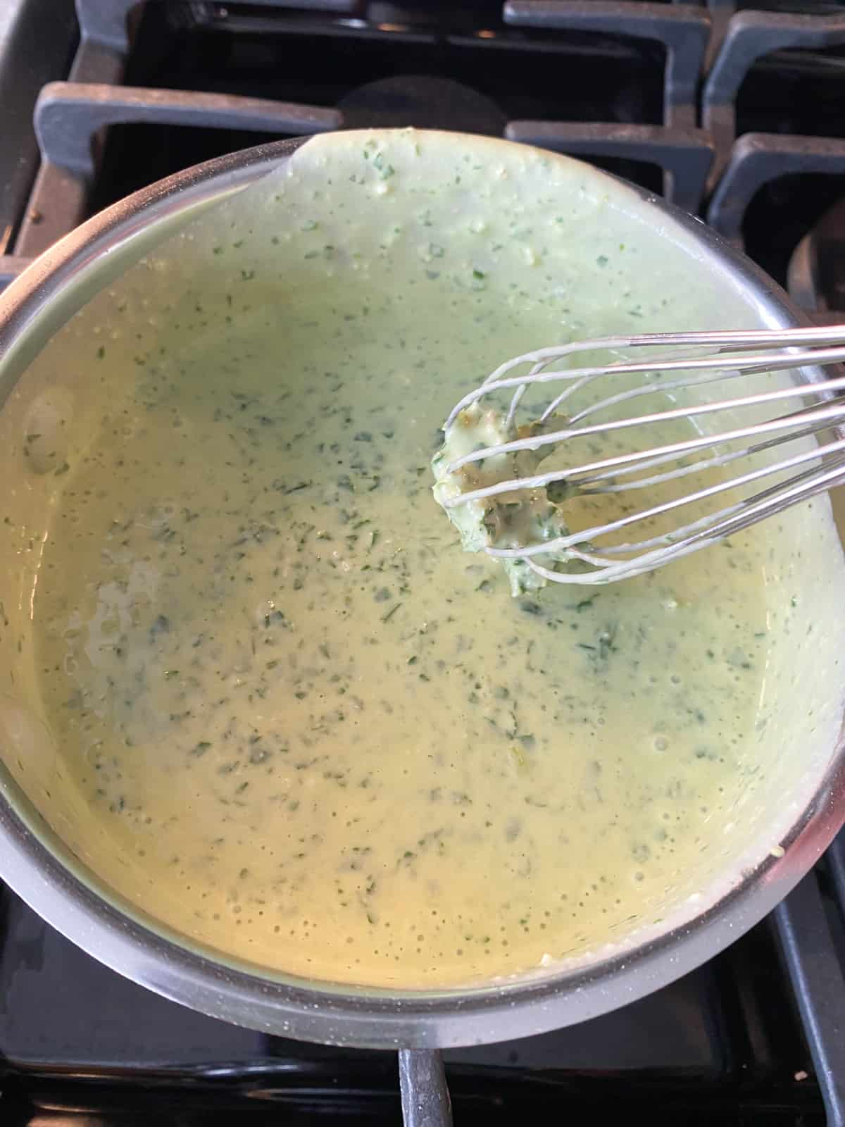 Pesto sauce added to, and whisked into, the roux.