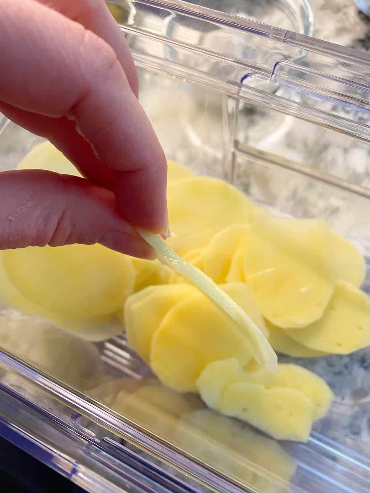 Peeled potatoes, sliced very thin using a mandolin.