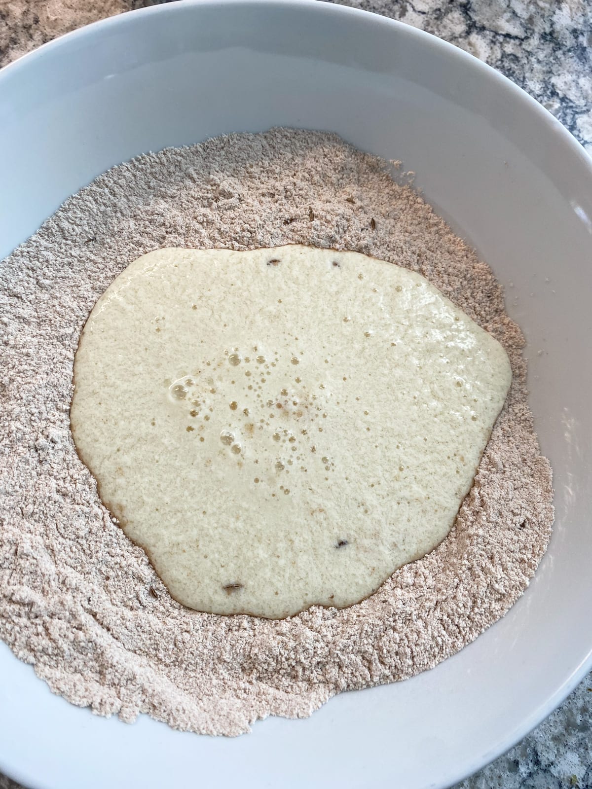 Wet ingredients added to dry biscuit ingredients.