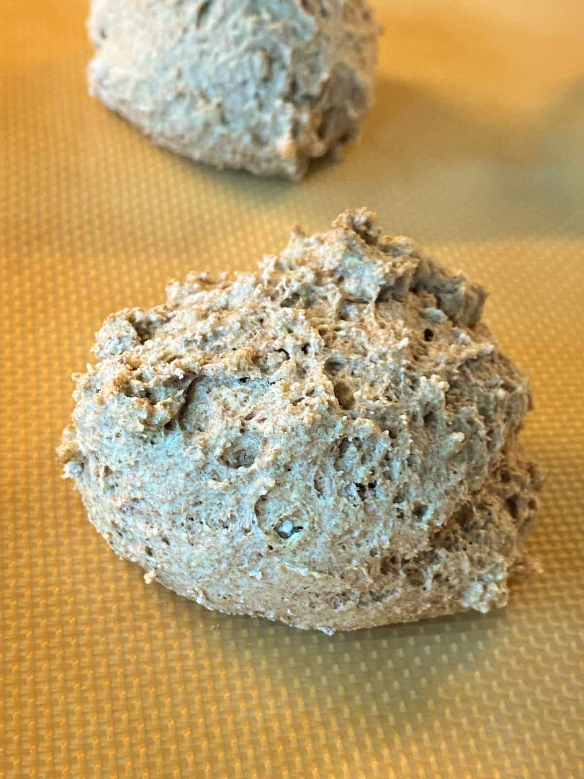 Close up of a baked biscuit on a baking sheet.