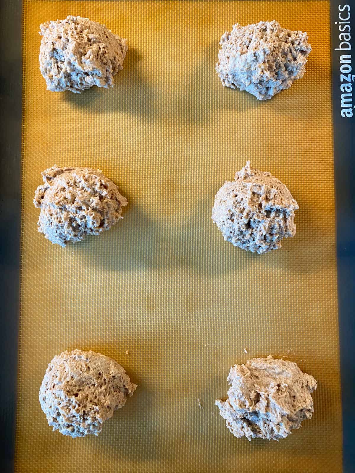 Biscuit batter scooped onto a baking sheet, in 6 servings.