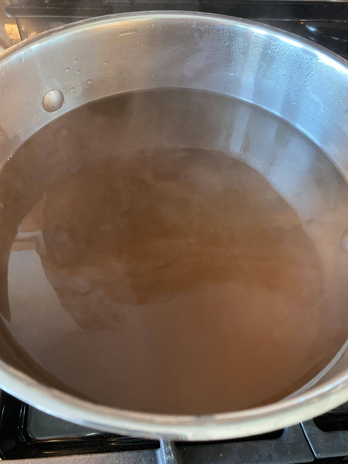 Finished vegetable stock in a large pot.