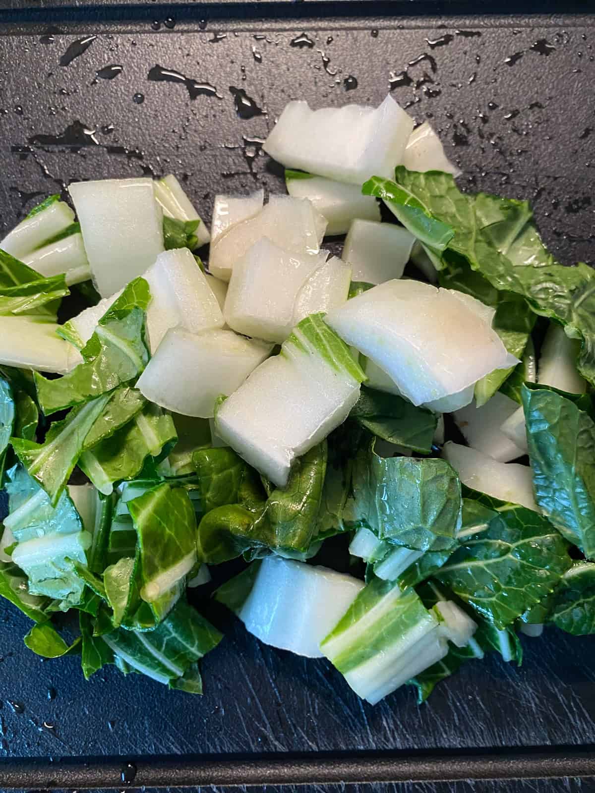 Bok choy, chopped, on a cutting board.