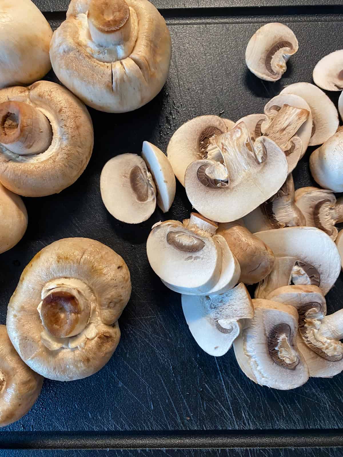 Sliced mushrooms on a cutting board.