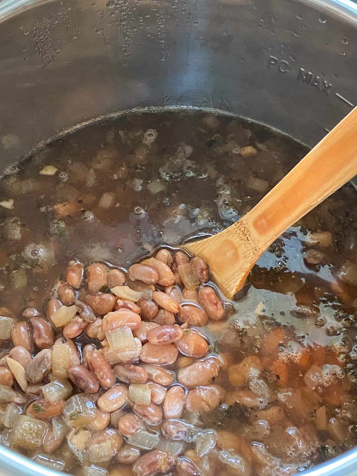Cooked pinto beans, in pressure cooker, undrained.