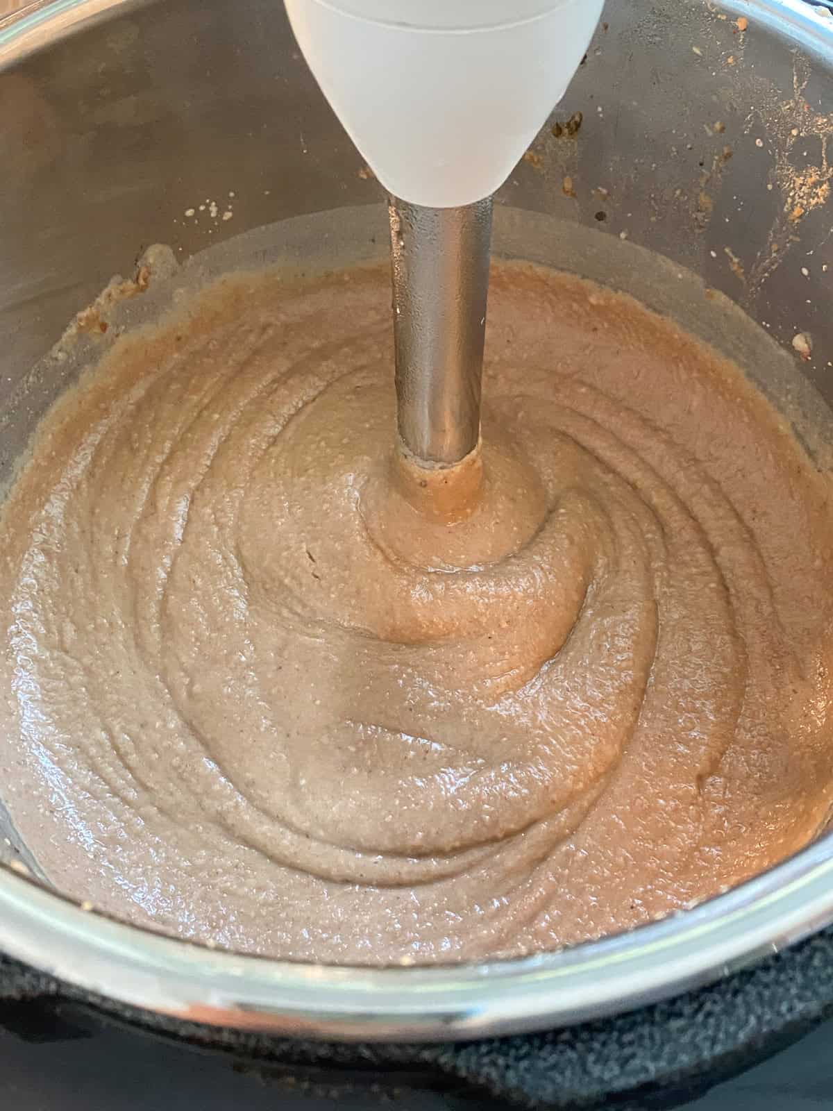 Finished refried beans in a pressure cooker pot.