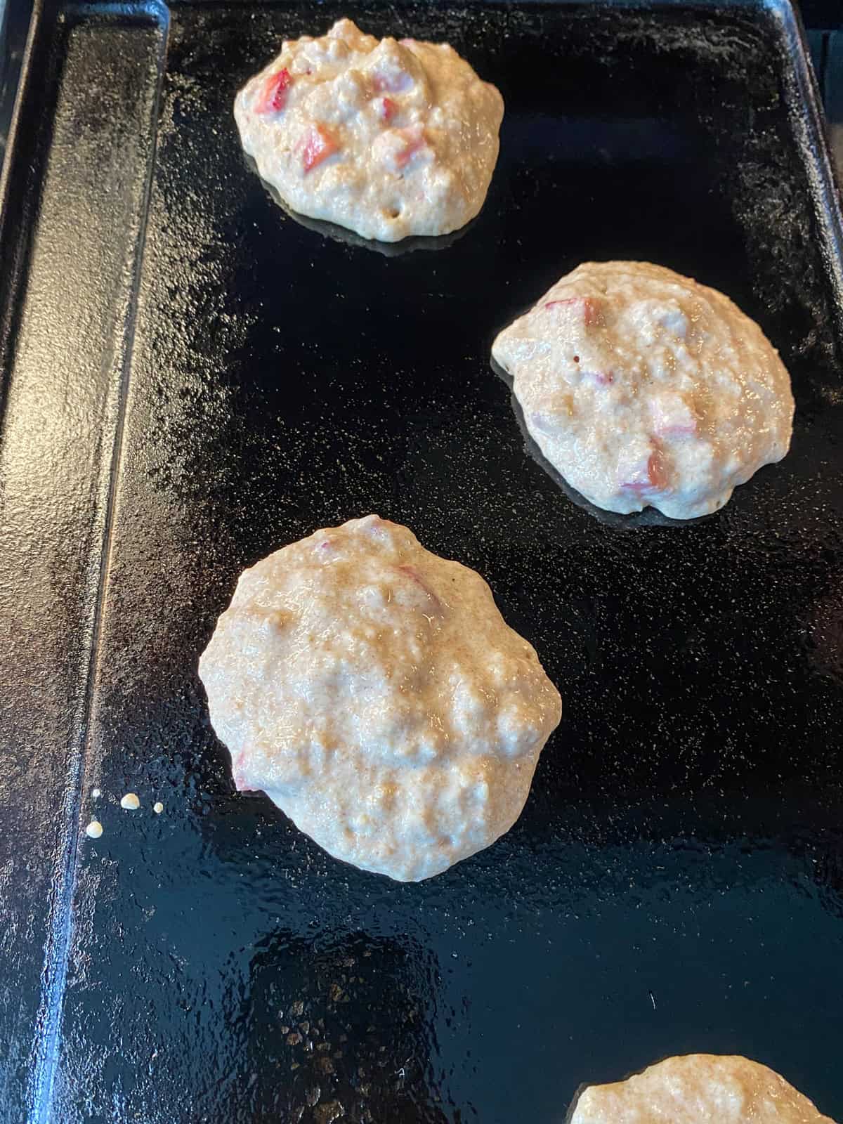 Pancake batter on a griddle.