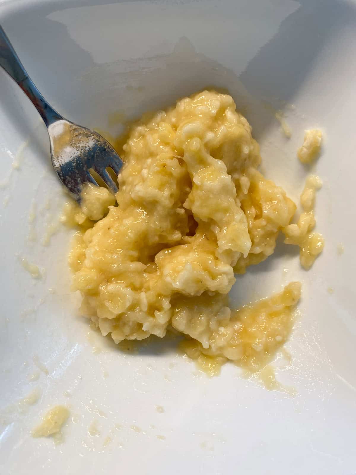 Mashed banana in a bowl.