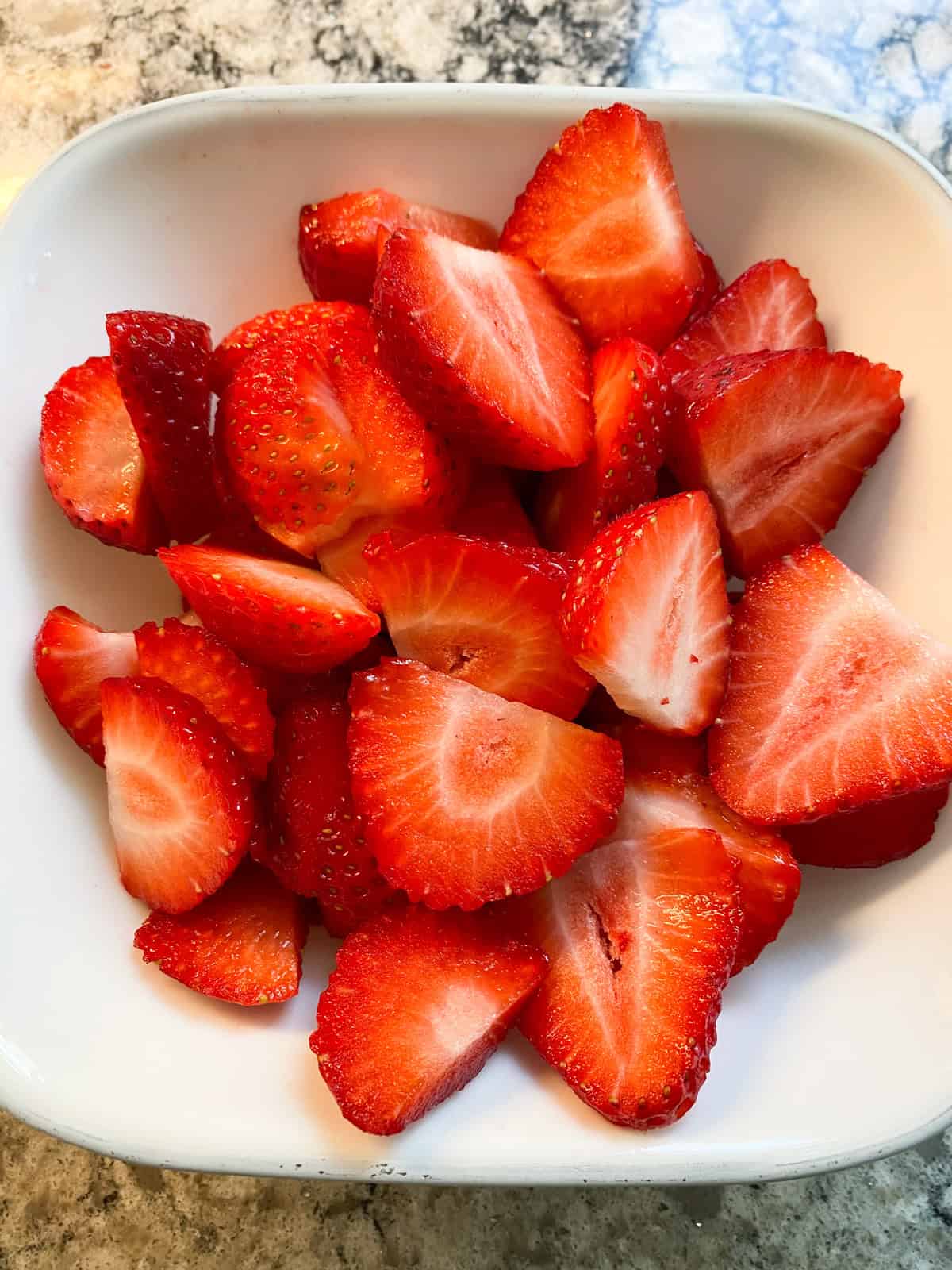 Strawberry slices in a bowl.