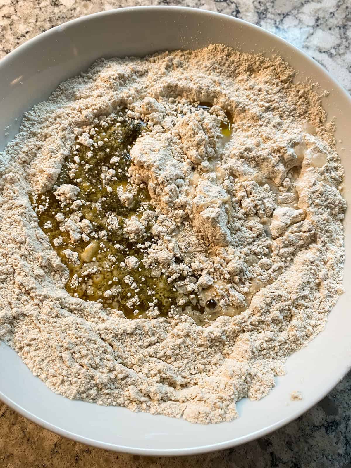 Wet pie crust ingredients poured into dry ingredients.