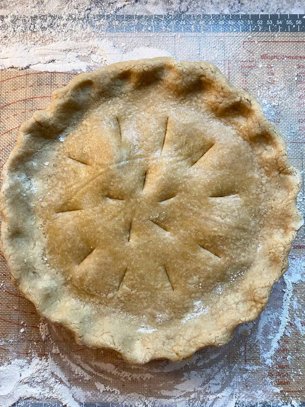 Vent holes cut into the top of the pie before baking.