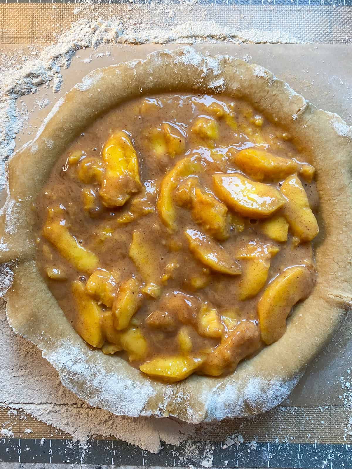 Peach pie filling poured into the bottom crust.