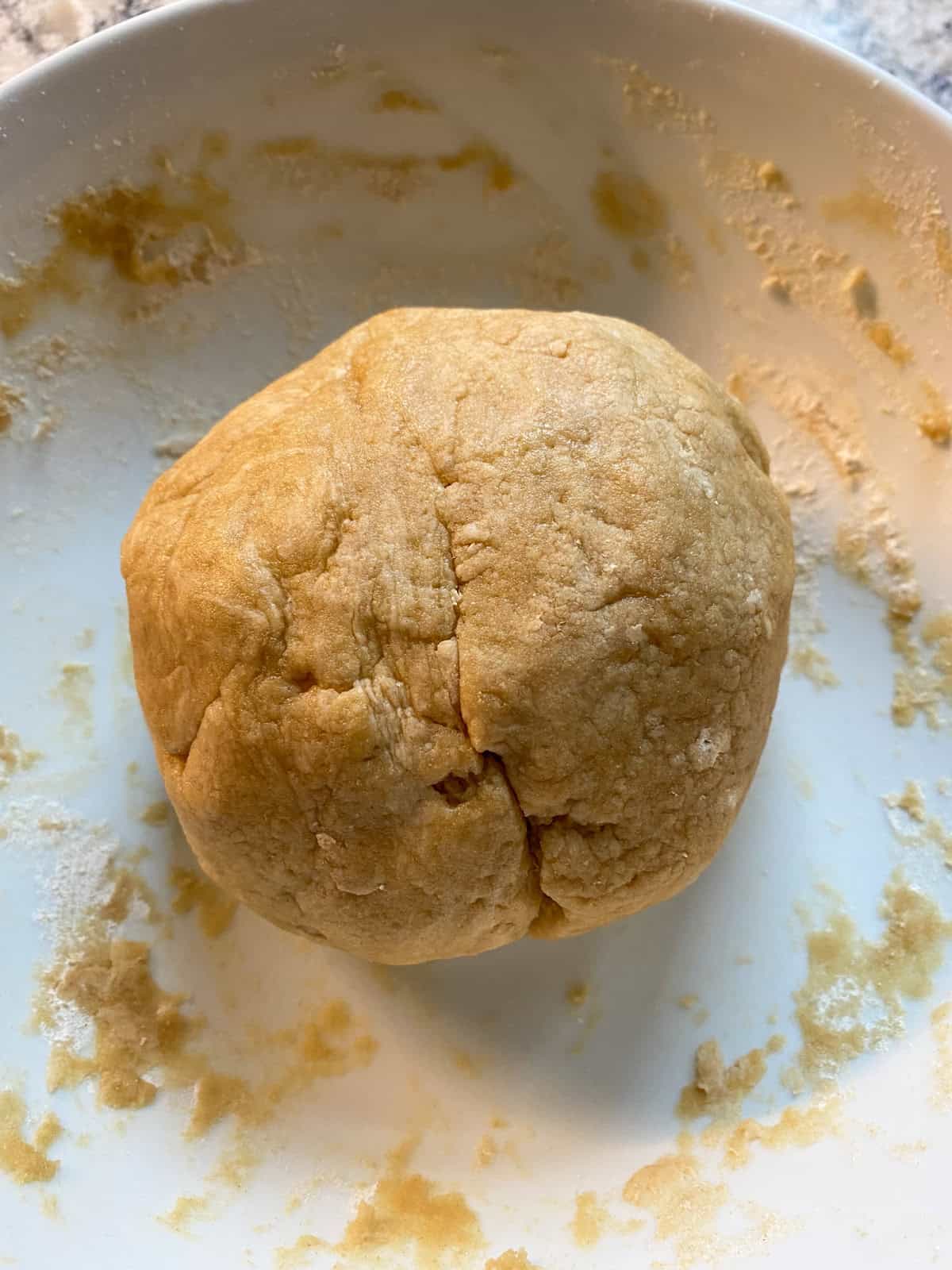 Mixed whole wheat pie dough in a bowl.