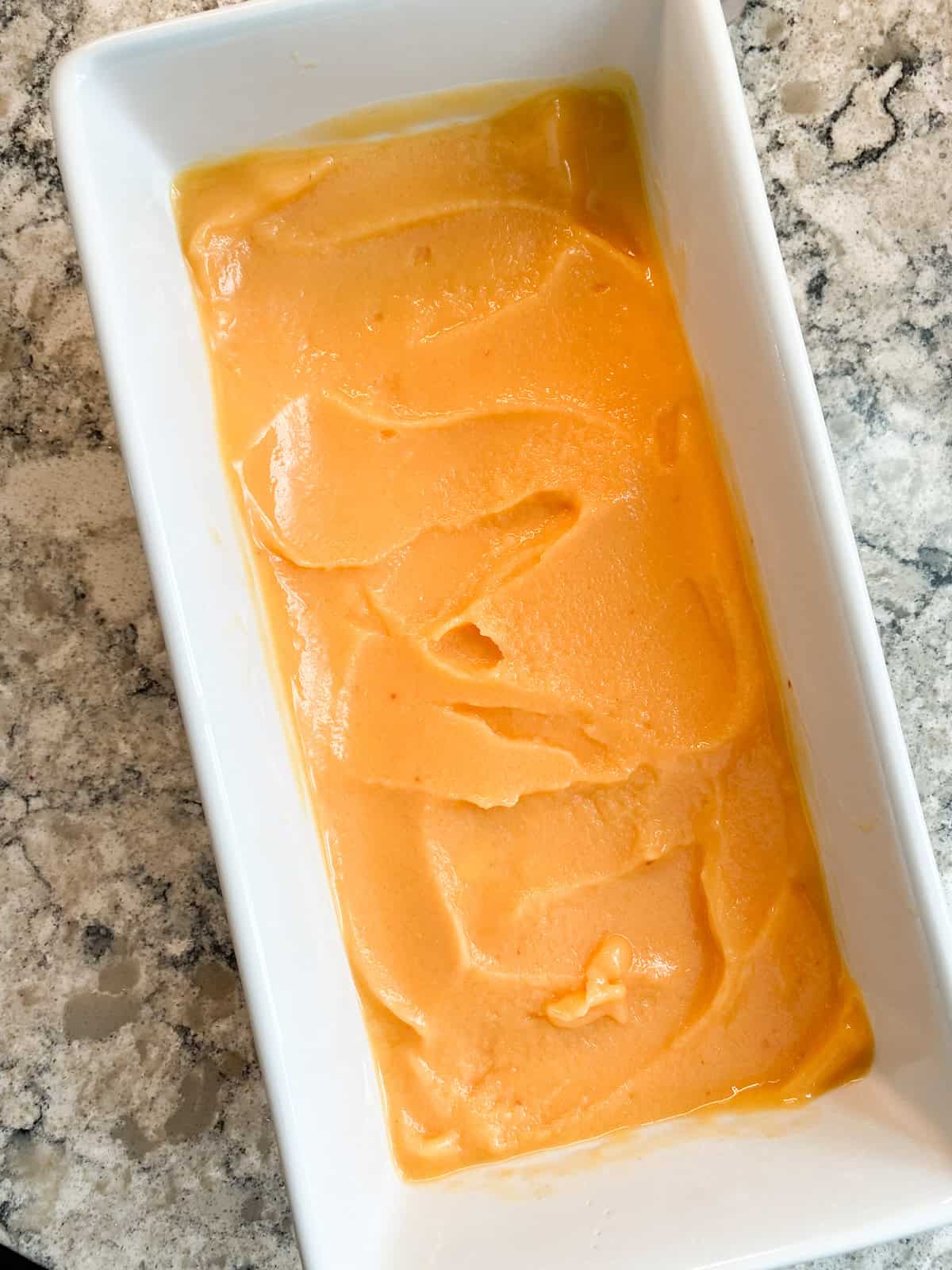 Rectangular ceramic dish with sorbet in it.