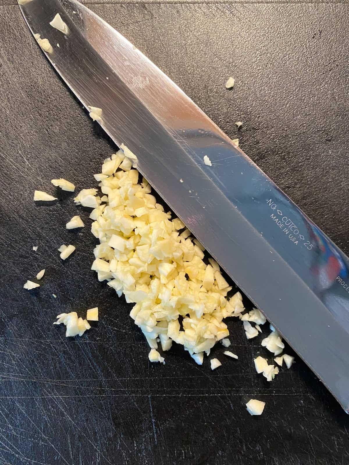 Minced garlic on a cutting board.