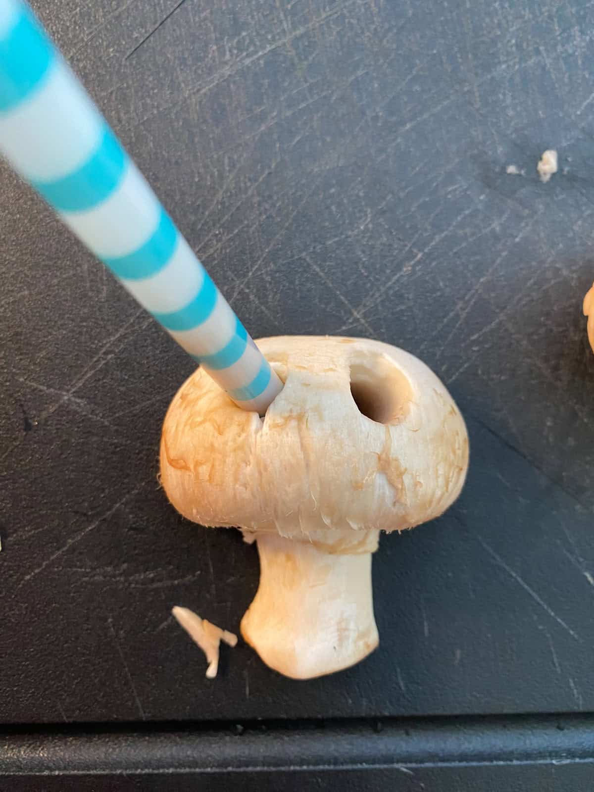 A plastic straw used to cut eye holes in the mushroom cap.