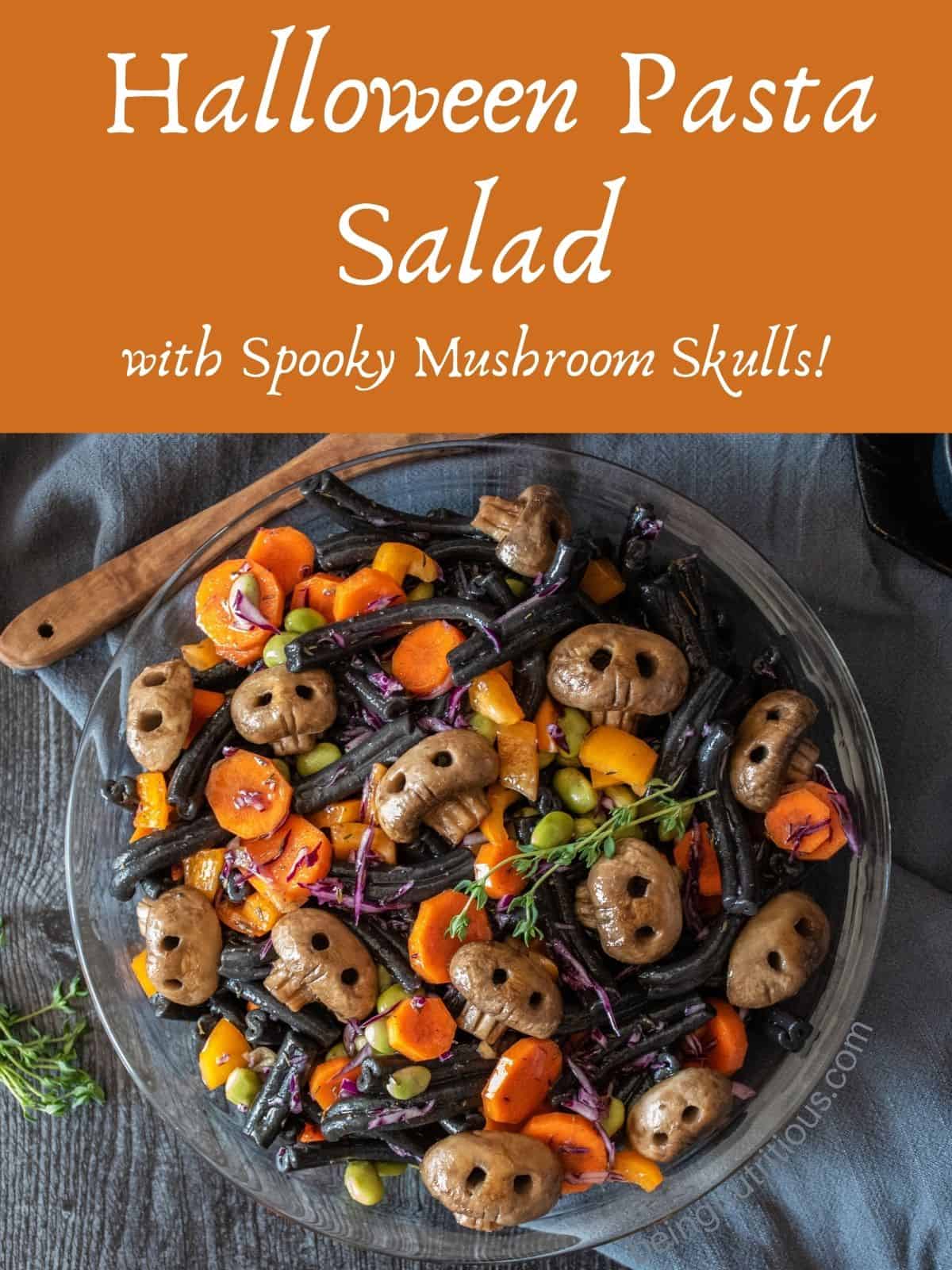 Overhead image of pasta salad in a dish. Text overlay: Halloween Pasta Salad with spooky mushroom skulls.
