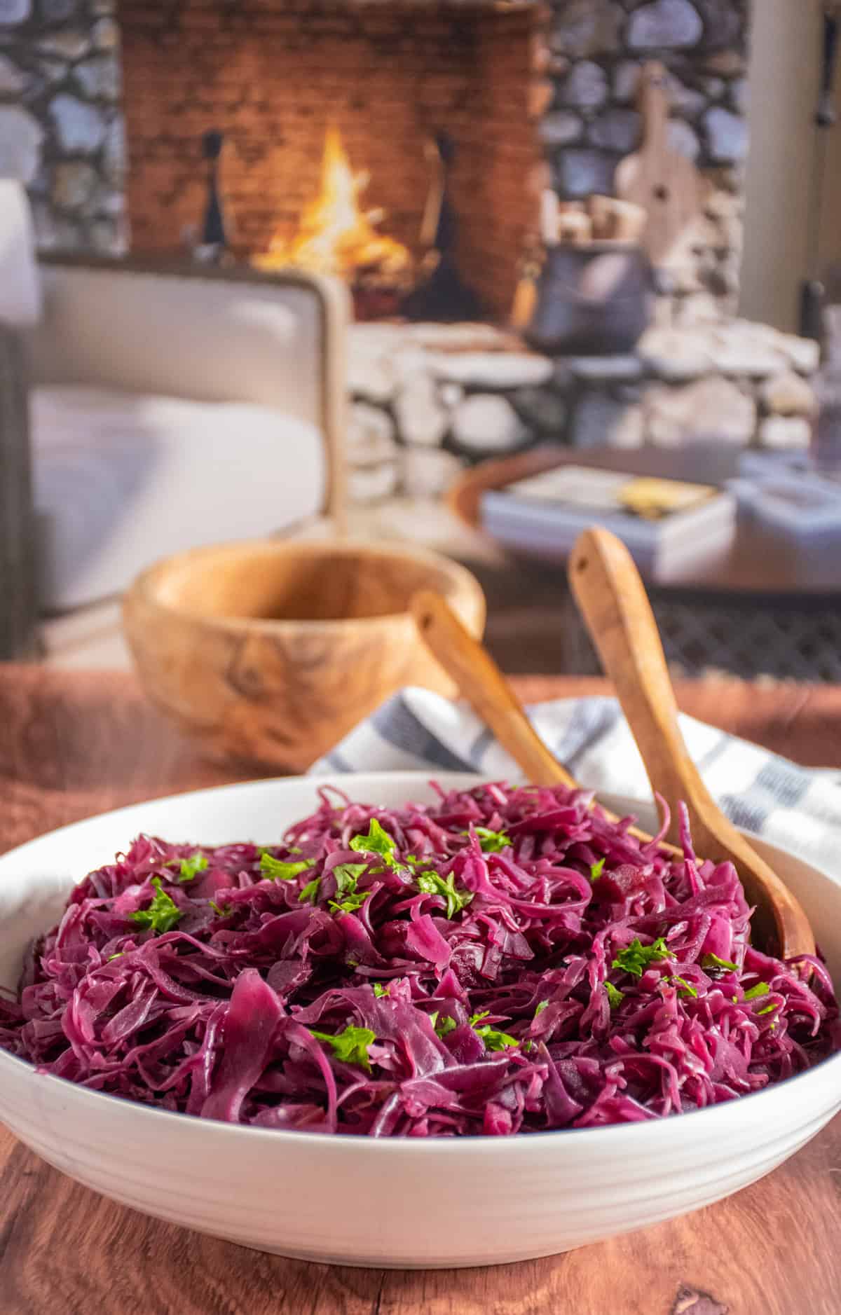 Bowl of cooked red cabbage with wooden spoons in the bowl.