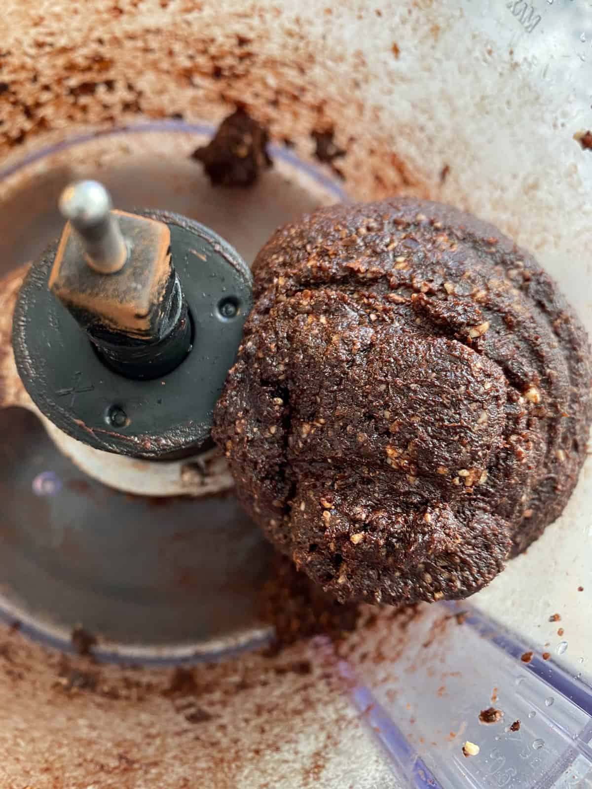 Dough coming together inside a food processor.