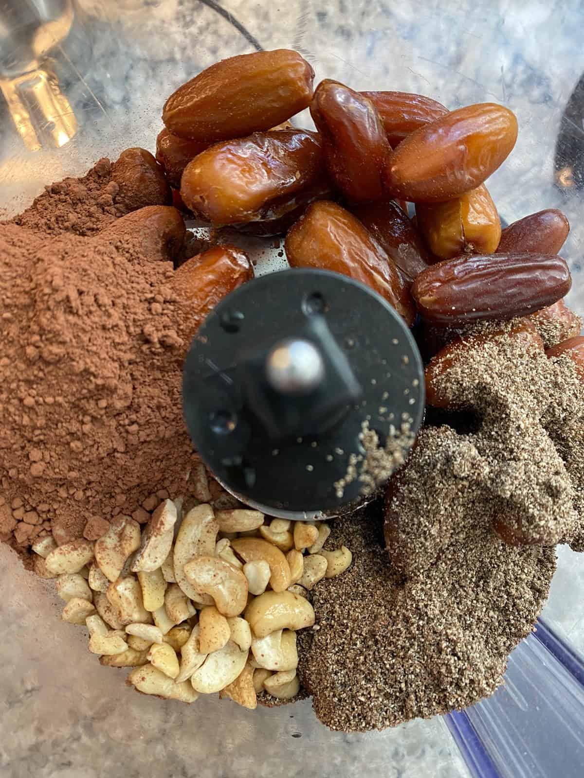 Ingredients for hot cocoa cookies in a food processor.