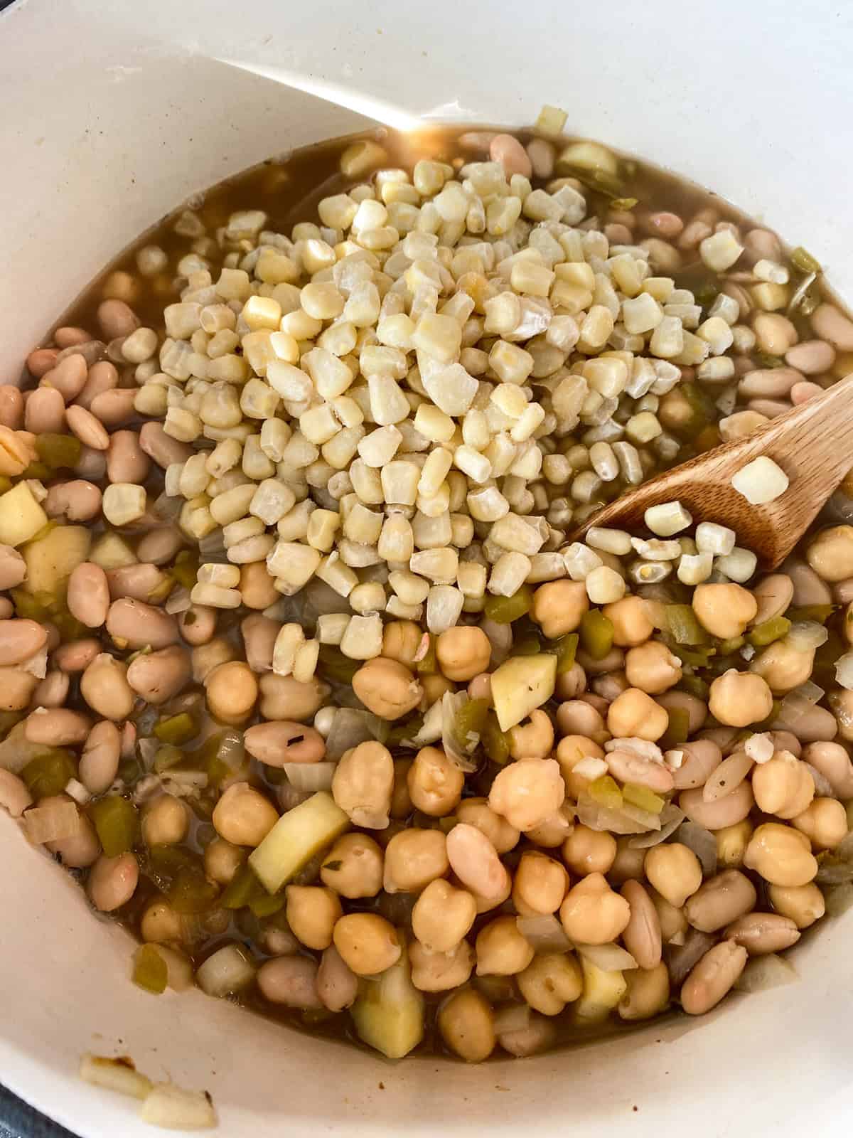Beans and corn added to the pot.