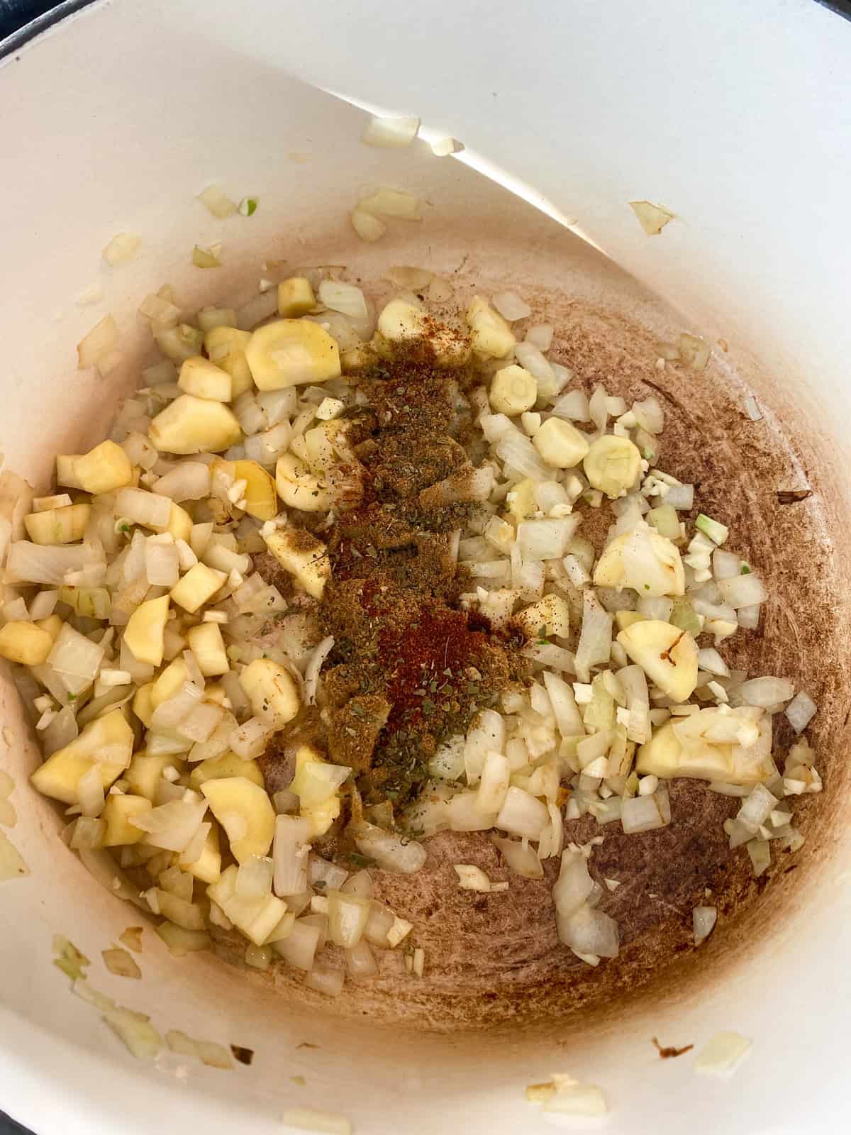 Spices sprinkled over sauteing veggies.