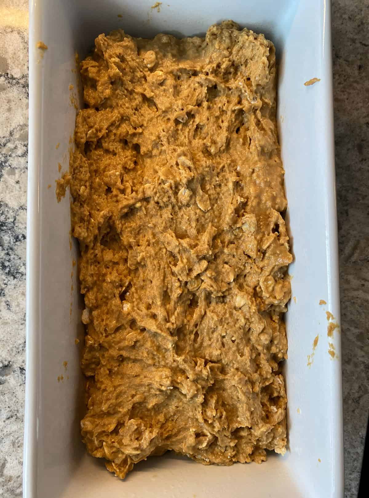 Bread batter in a loaf pan.