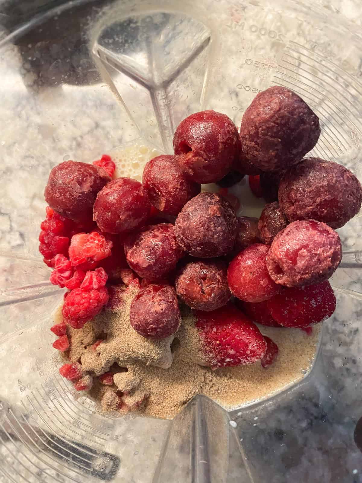 Pink smoothie ingredients in a blender.