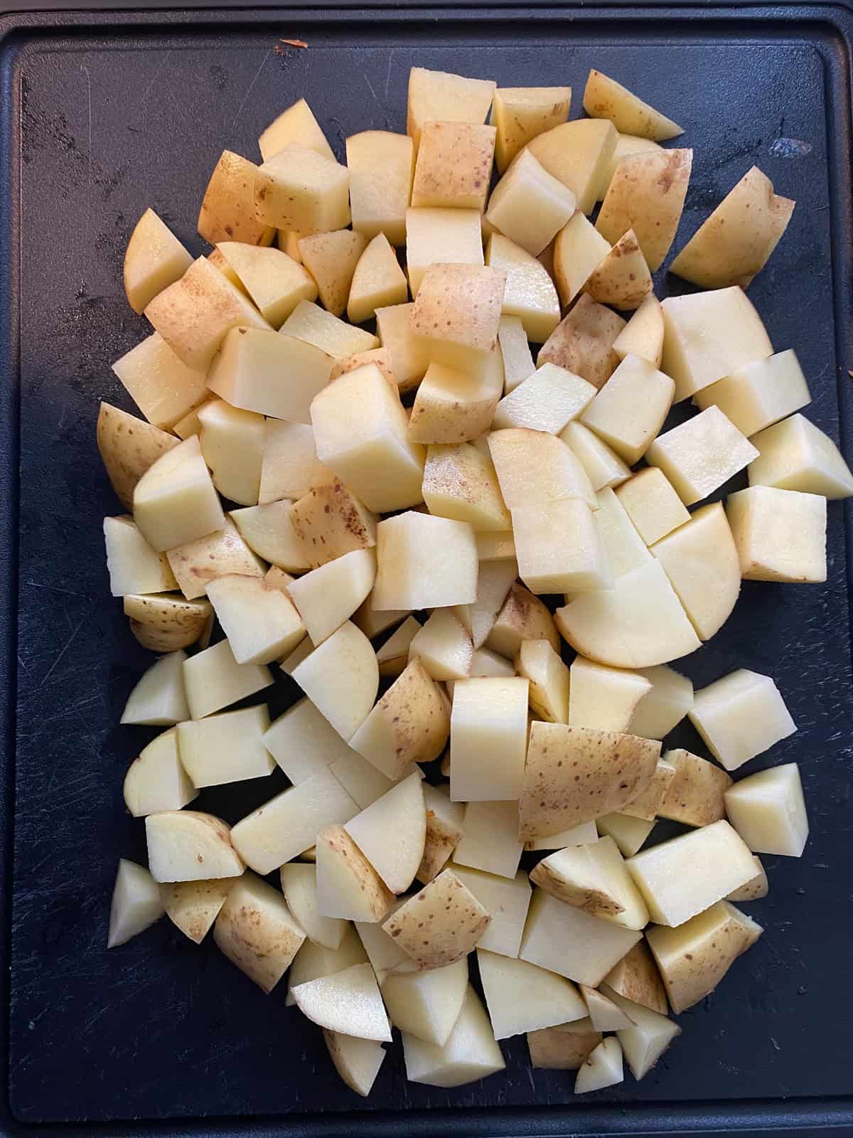 Chopped potatoes on a cutting board.