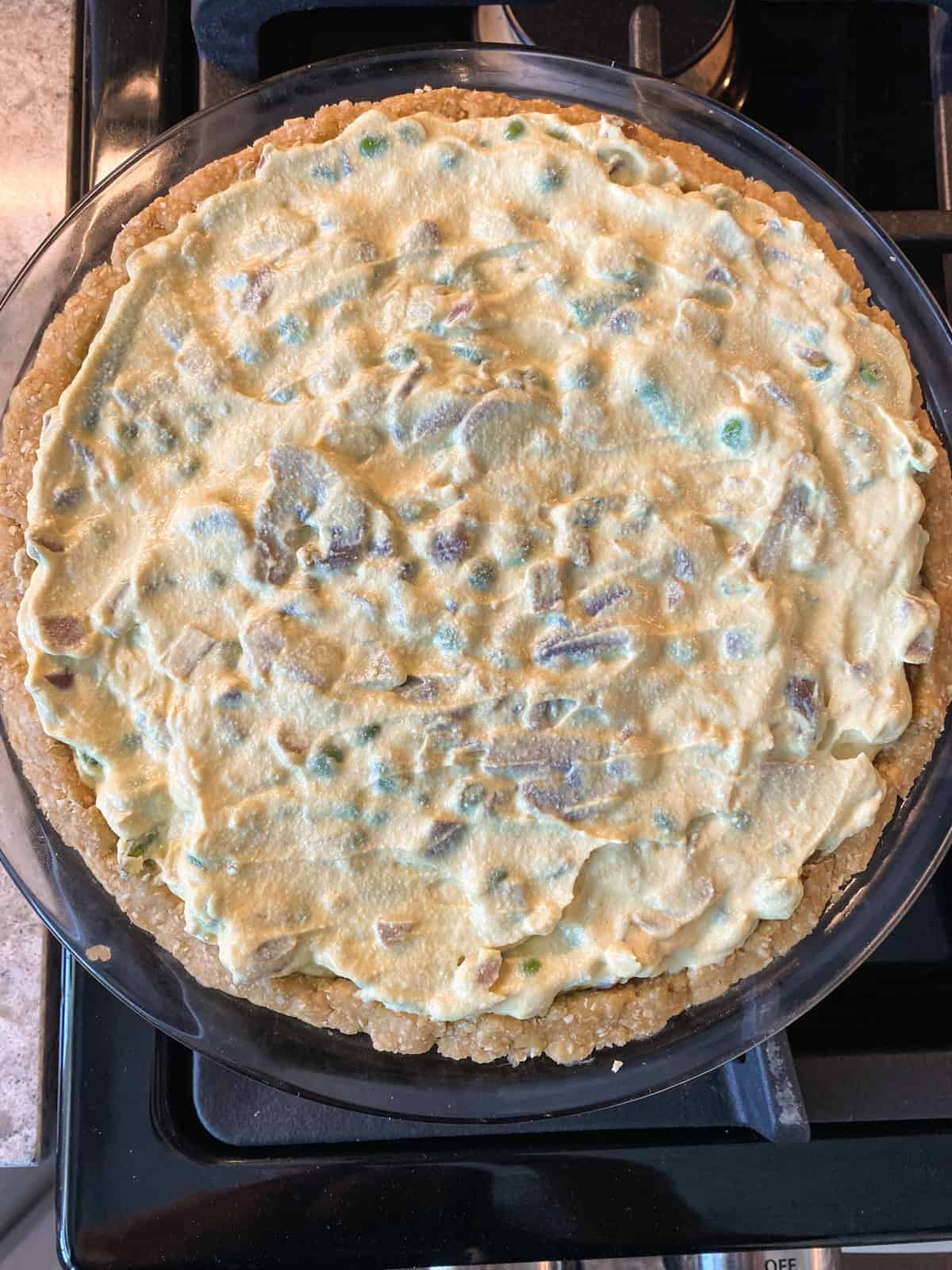 Filling in pie crust, ready to bake.
