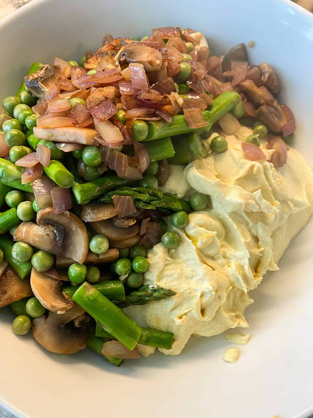 Sauteed vegetables and processed tofu in a bowl.