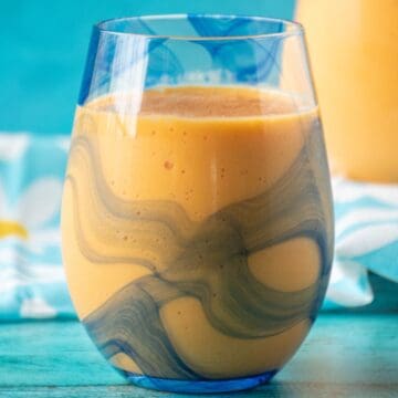 Close up glass of mango orange smoothie.