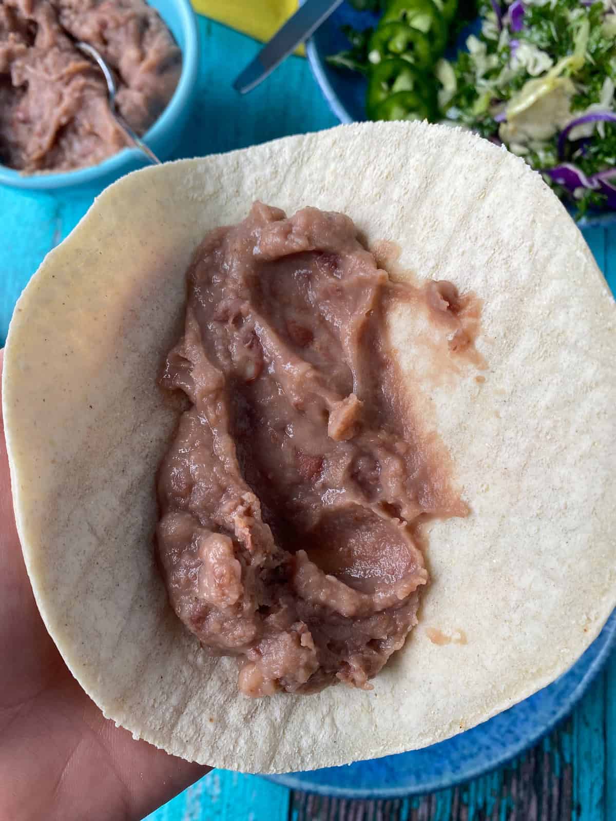 Corn tortilla with refried beans.