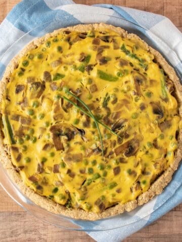 Overhead image of whole eggless quiche in a pie plate.