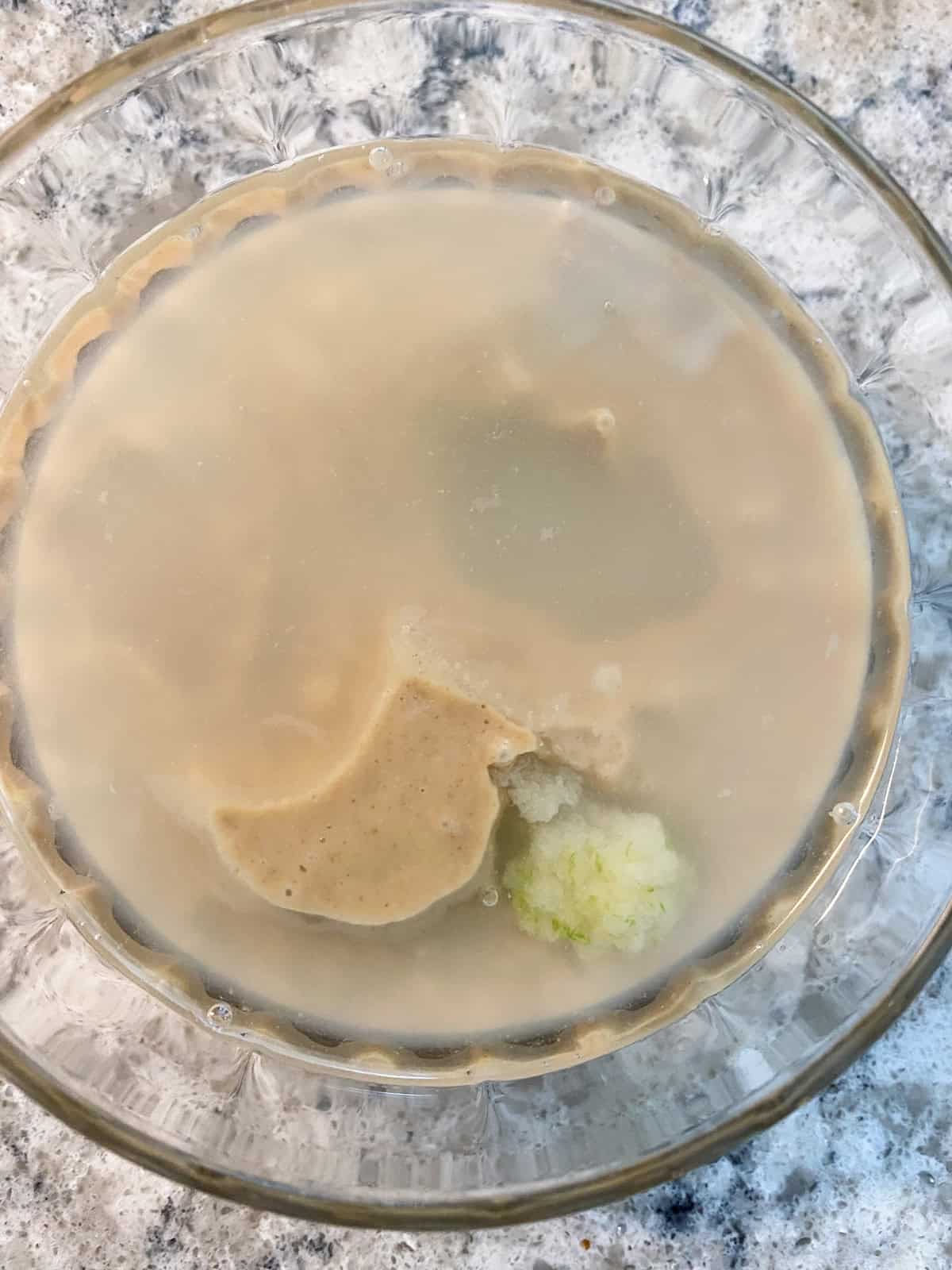 Tahini dressing ingredients in a bowl.