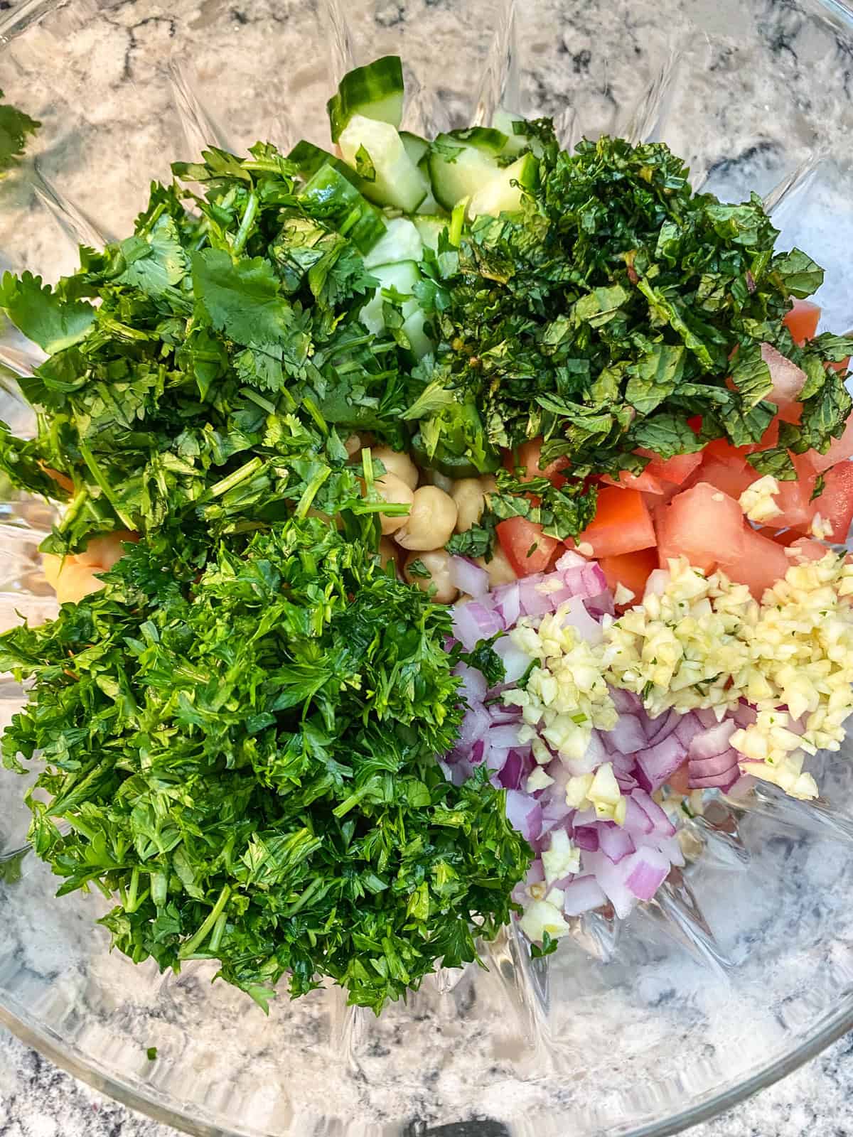 Chopped herbs added to the salad bowl.
