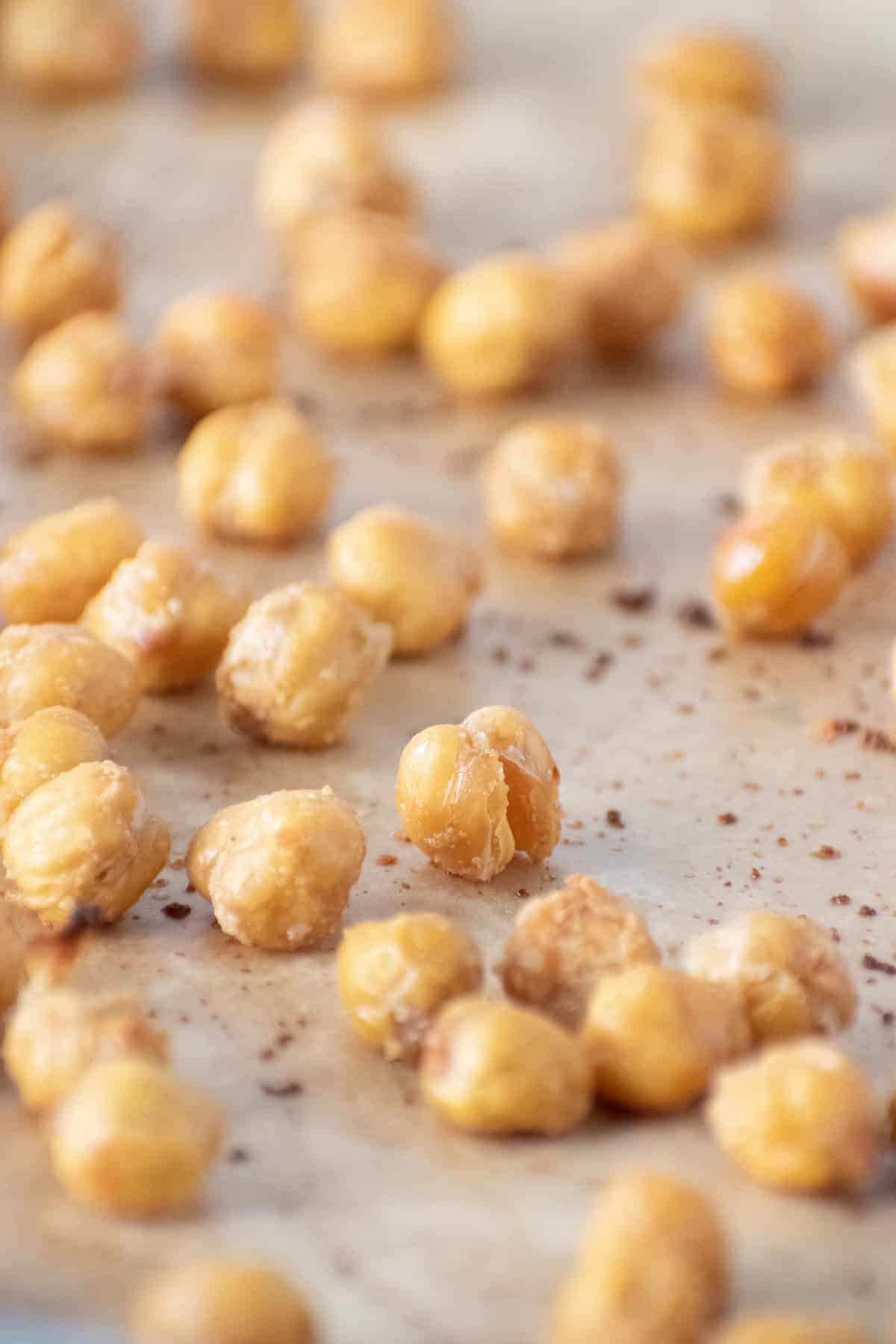 Close up of baked chickpeas on a baking sheet.