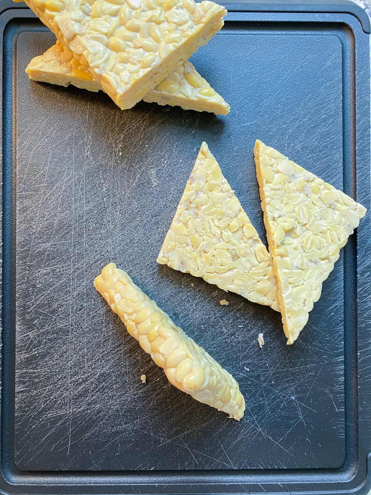 Tempeh triangles sliced in half.