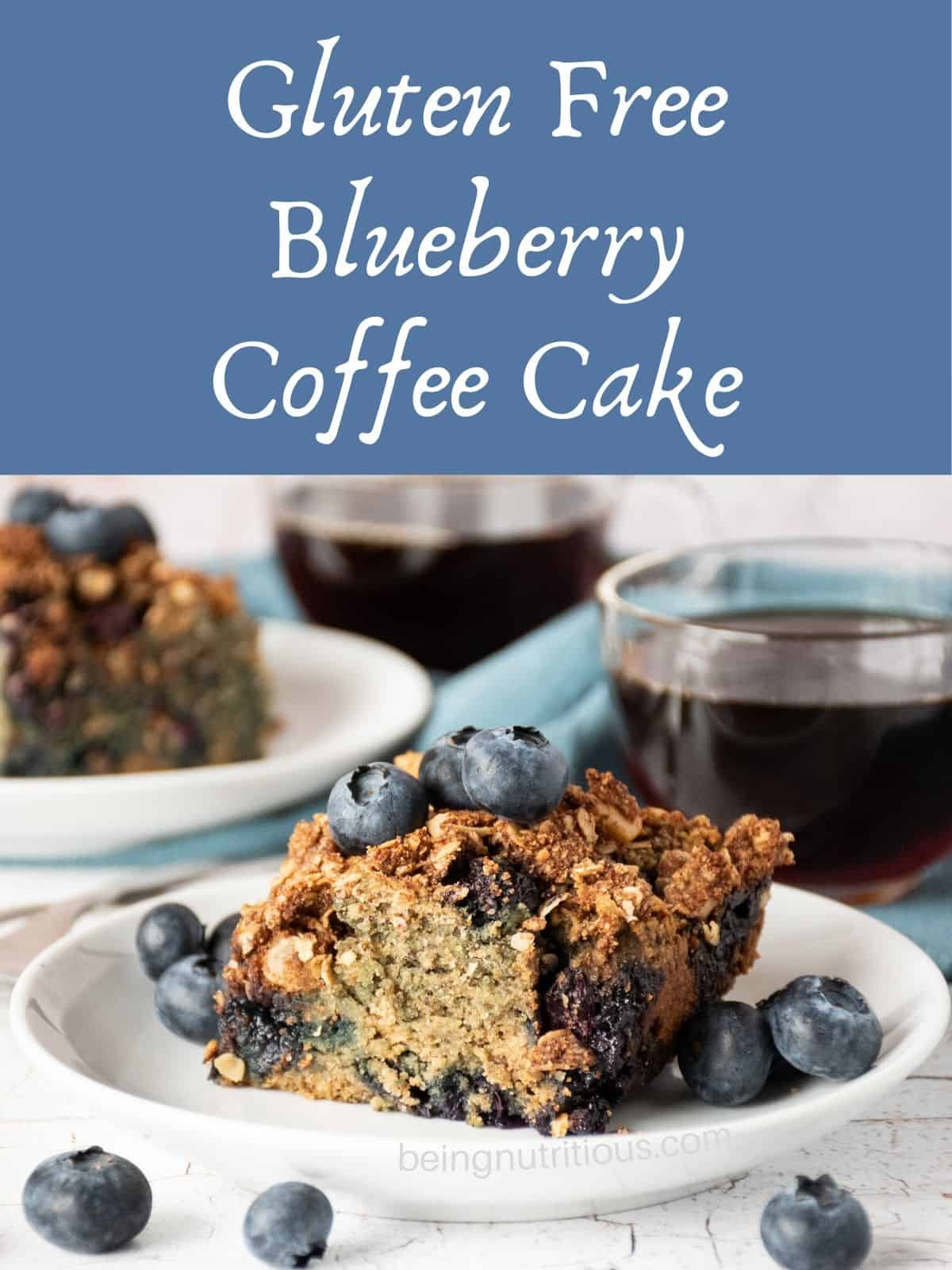 Slice of coffee cake on a plate, garnished with blueberries, with a cup of coffee in the background. Text overlay: Gluten Free Blueberry Coffee Cake.