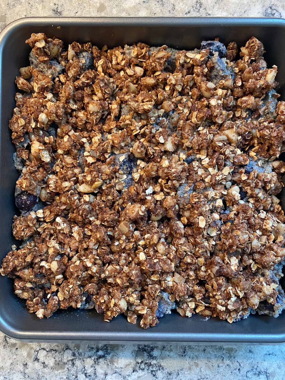 Batter in a pan, with crumb topping on, ready to bake.