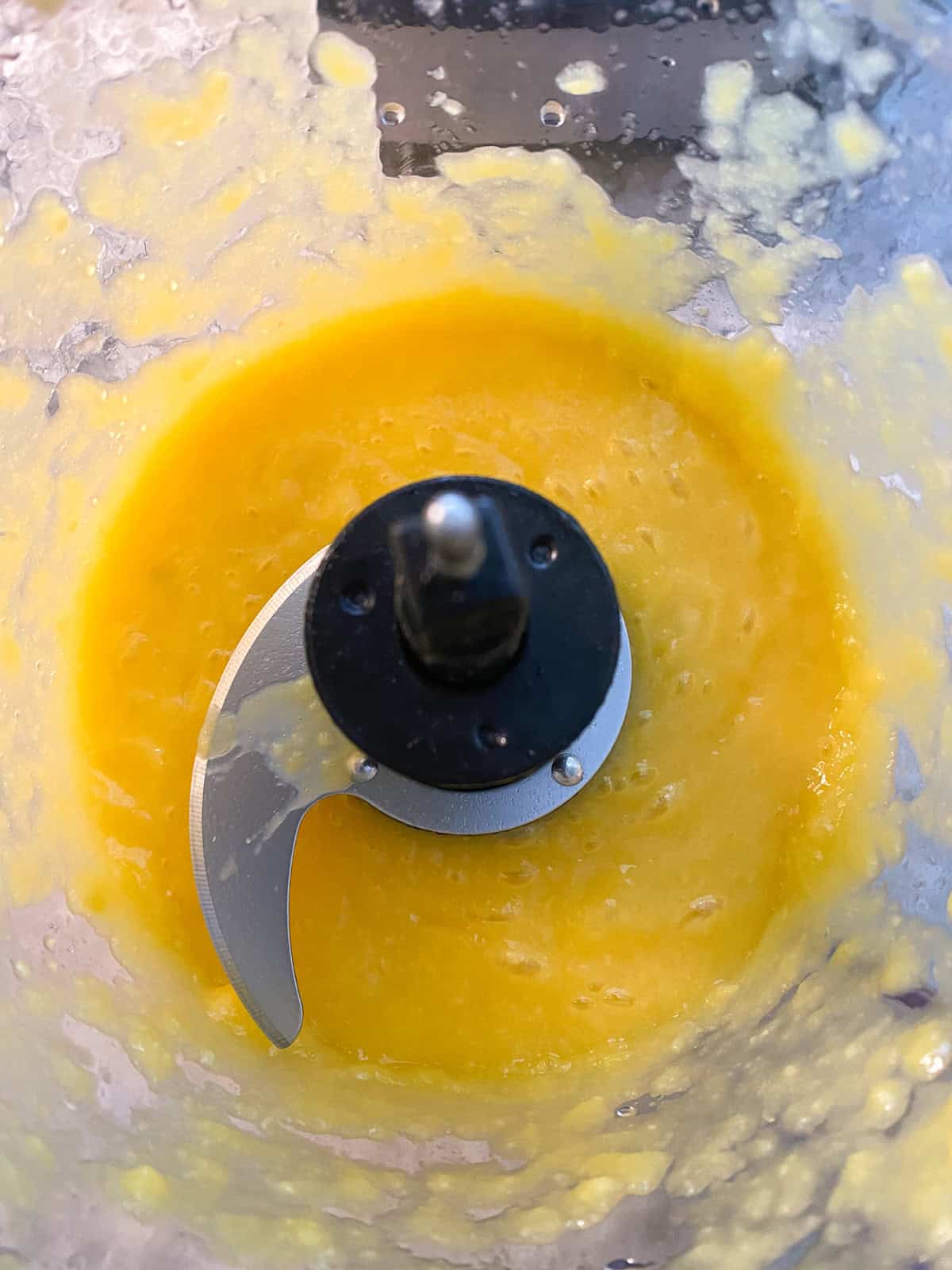 Pureed mango in a food processor.