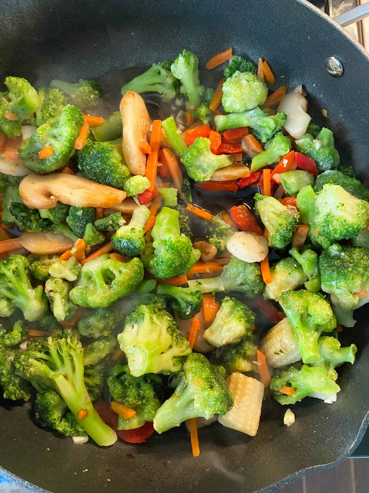 Soy sauce added to cooking vegetables.