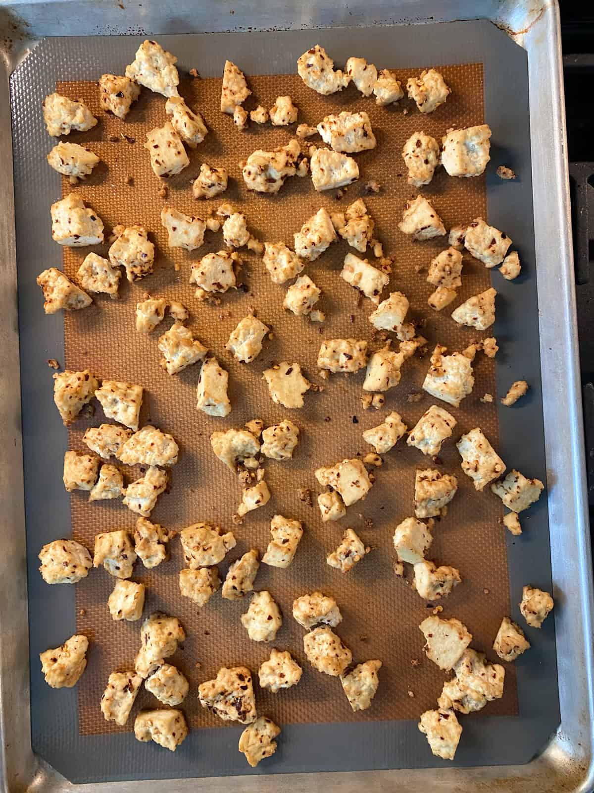 Baked sesame tofu on a baking sheet.